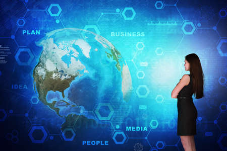Business woman in front of holographic screen with earth globe.