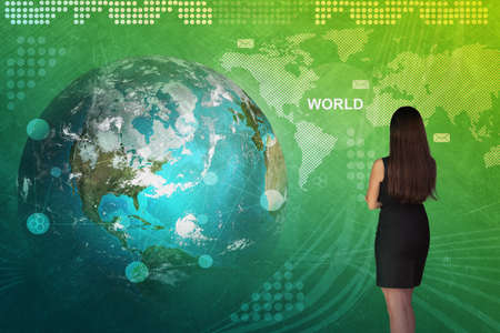 Business woman in front of holographic screen with earth globe.の写真素材