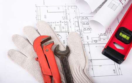 Architecture plan with gloves and turn-screws. Building conceptの写真素材