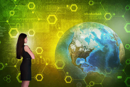 Business woman in front of holographic screen with earth globe and numbers. Elements of this image furnished by NASAの写真素材