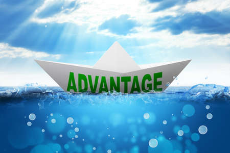 Origami paper boat with word advantage in oceanの写真素材