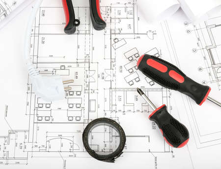 Architecture plan and rolls of blueprints with pliers and screwdriver. Building conceptの写真素材