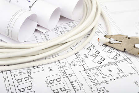 Architecture plan and rolls of blueprints with cabel and pliers. Building conceptの写真素材