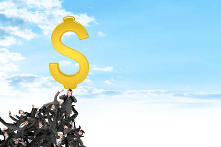 Pile of businessmen with gold dollar sign on top, business conceptの写真素材