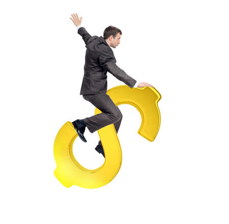 Businessman riding golden dollar sign isolated on white backgroundの写真素材