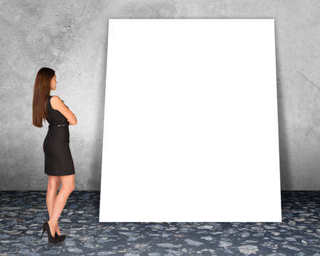 Big blank banner with businesslady on grey wall backgroundの写真素材