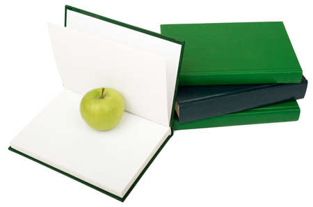 Notebooks with green apple isolated on white backgroundの写真素材