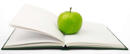 Fresh apple on notebook isolated on white backgroundの写真素材