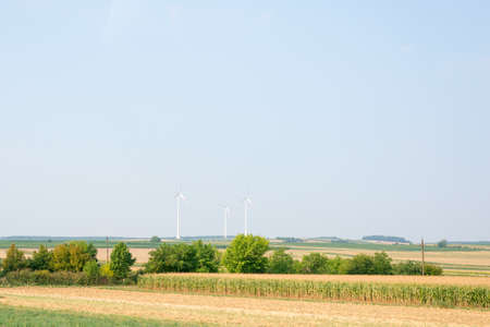 Landscape view with fields and wind power stationの写真素材