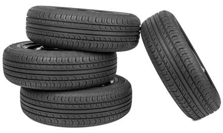 Stack of four wheel new black tyres, isolated on white backgroundの写真素材