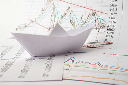 Business concept, Paper boat floats on documentsの写真素材