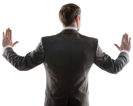 Rear view of young business man pointing at copy space isolated over white background, portrait of businessman standing backの写真素材