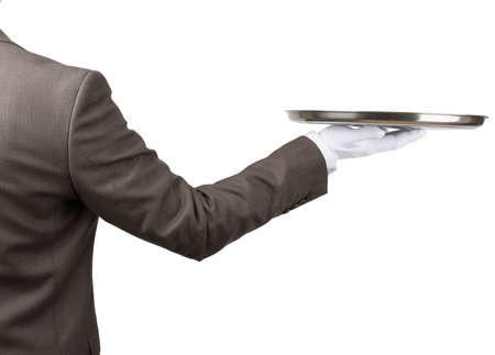 Arm in white glove with empty flat plate isolated on white backgroundの写真素材