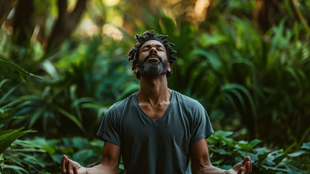 Man sitting meditating in the forestの素材