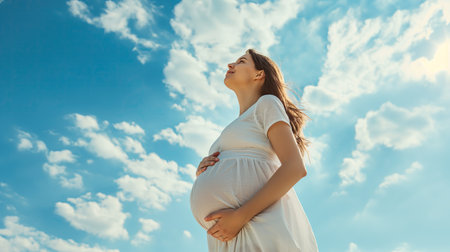 Young pregnant woman breathing clean airの素材