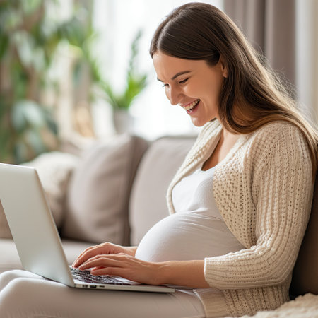Young pregnant woman working on laptopの素材