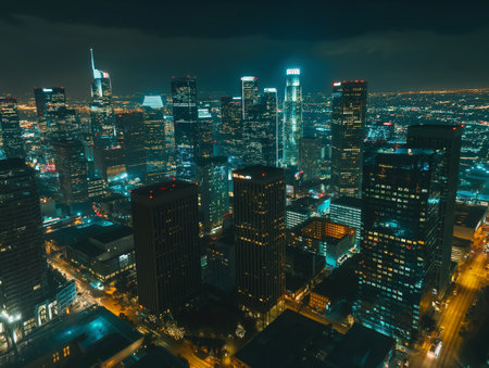 An aerial view captures the vibrant energy of a city at night, with illuminated streets and buildings forming a glowing gridの素材
