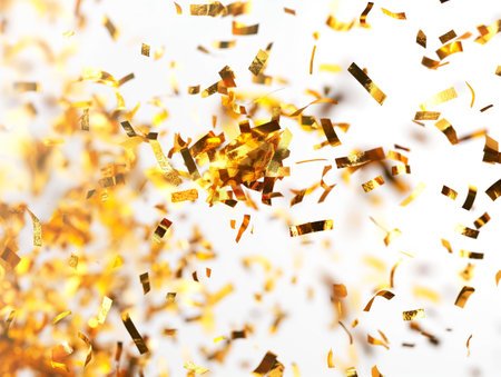 A vibrant shower of golden confetti floats in the air, adding a festive sparkle to celebrations.の素材
