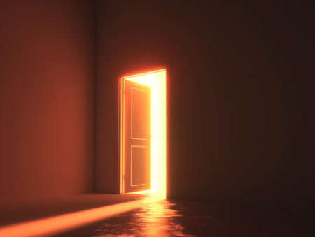 A single open door glowing with bright light in a darkened room symbolizes opportunity, hope, and the unknown.の素材