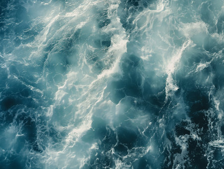 Aerial view of chaotic ocean waves, capturing the dynamic textures of sea foam and water.の素材