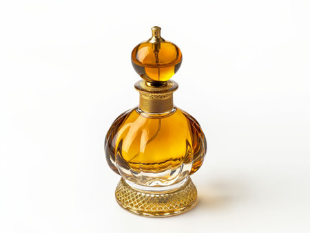 A luxurious clear and amber glass perfume bottle with intricate details on a white background.の素材