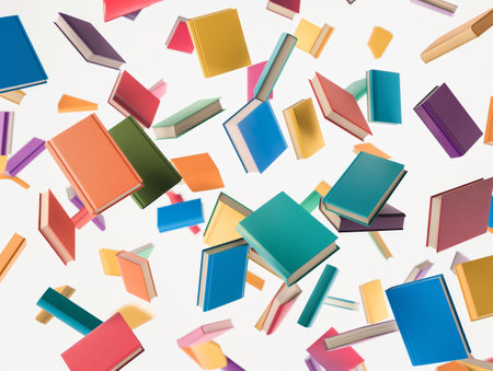 A vibrant collection of books seemingly suspended in space against a white backgroundの素材