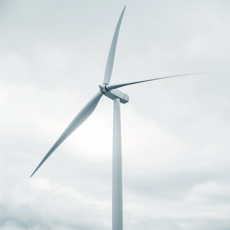 Clean energy concept with a close-up view of a wind turbine blade and nacelle against a cloudy backdrop.の素材