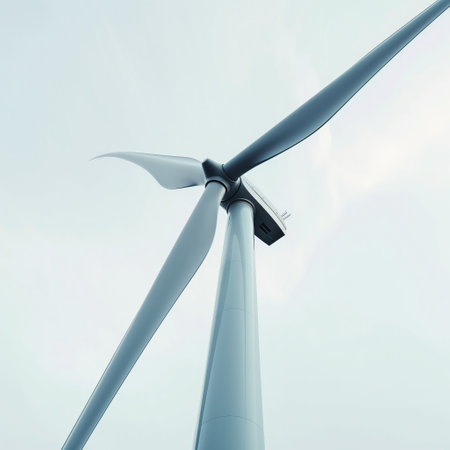 Close-up view of a wind turbine showcasing sustainable energy against a serene blue sky.の素材