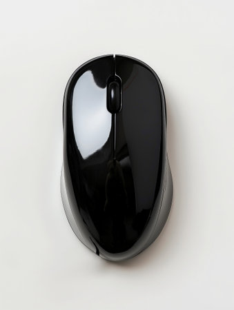 Simple and modern black wireless mouse isolated on a white background, showcasing design and technology.の素材