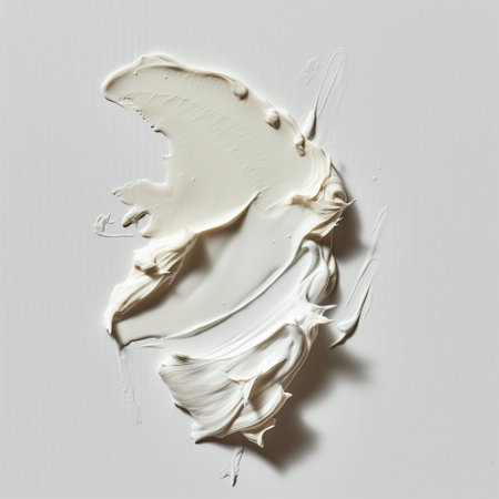 A textured smear of white cream against a solid background evokes a sense of softness and purity.の素材