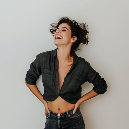 A woman exudes happiness with a wide, carefree laugh.の素材