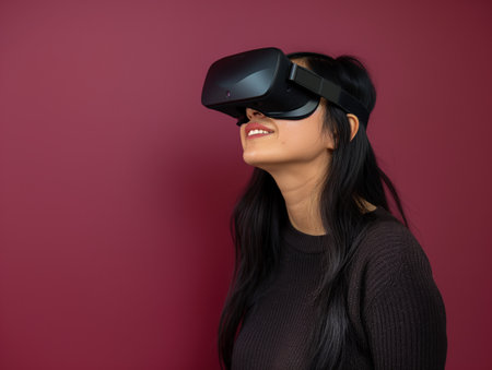 A smiling woman wearing a VR headset against a red background, engrossed in virtual content.の素材