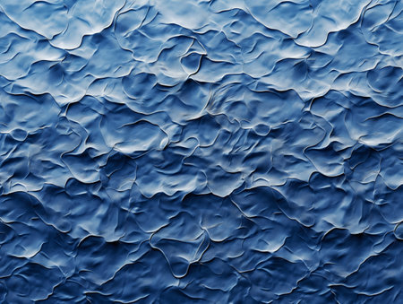Close-up of an abstract blue textured surface with wavy, organic patterns, evoking a sense of fluidity and movement.の素材