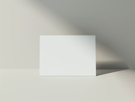 A blank white card is placed on a smooth, light-colored surface with soft shadows, creating a minimalist and clean aestheticの素材
