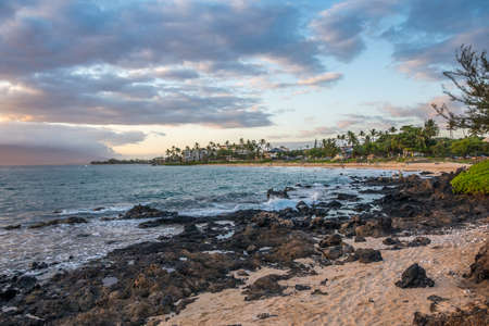 A beautiful view of whitecap waves roll onto the rocky beach of the preserve park
