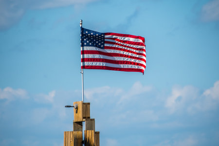 Rockport, TX, USA - April 18, 2019: A US flag on top of a poll at Rockport Beachのeditorial素材