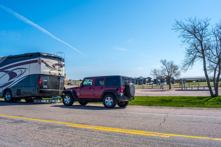 Alliance, NE, USA - May 5, 2019: A Jeep Wrangler parked alongside with a motorhome in the parkのeditorial素材