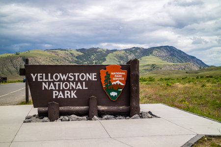 Yellowstone NP, WY, USA - June 23, 2019: A welcoming signboard at the entry point of the preserve...