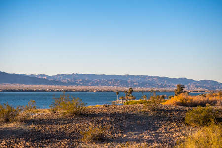 A large refreshing flow of water with a peaceful view of the lakeの写真素材