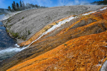 A geyser, steam and water boils from the ground in the well known preserve parkの写真素材