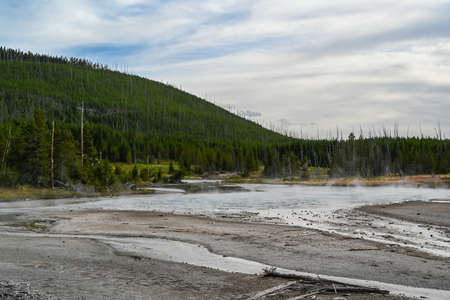 A geyser, steam and water boils from the ground in the well known preserve parkの写真素材