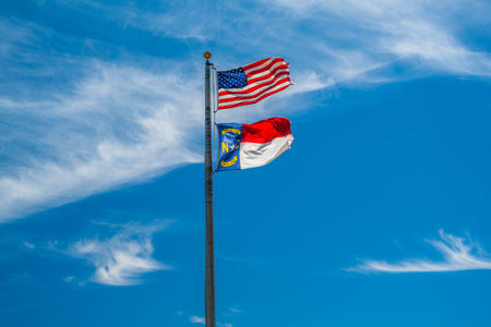 Cedar Island, NC, USA - Aug 13, 2022: A US flag on top of a poll at the city centerのeditorial素材