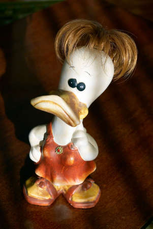 The figure of a ridiculous duck stands on a tableの写真素材