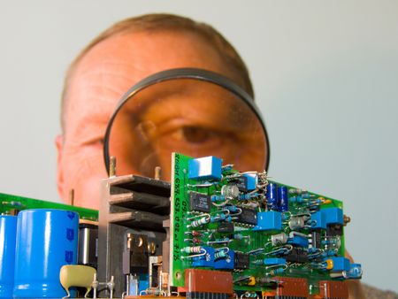  the engineer looks in a magnifier at chipsの写真素材