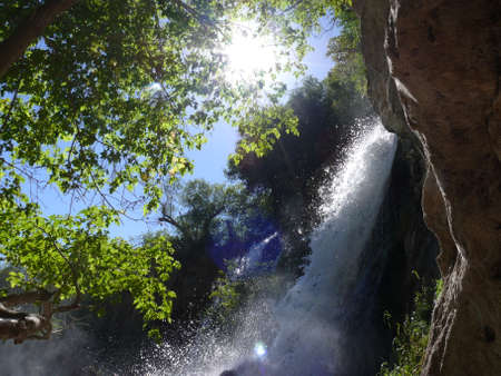 Sunshine Through the Trees With Waterfallの写真素材