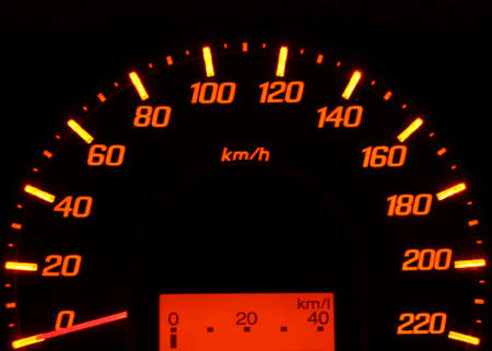 Close up to illuminated speedometer car dashboard and black background