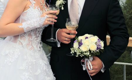 Bride and groom are holding champagne glassesの写真素材