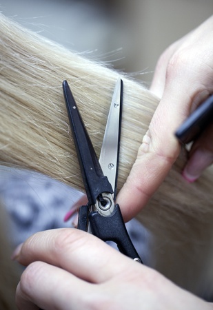 Hairdresser cuts hot scissorsの写真素材