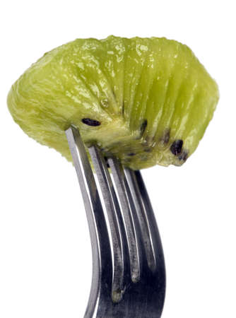 slice of kiwi fruit on a fork isolated on white backgroundの写真素材