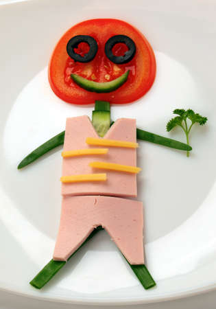man made of vegetables on a white plateの写真素材